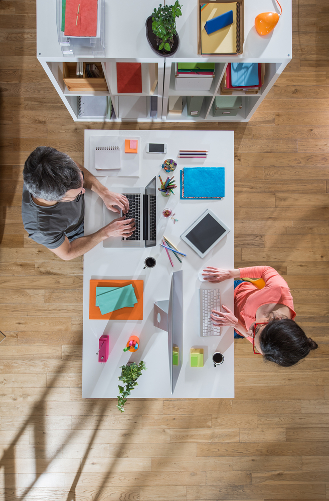 Two creative professionals working at desk